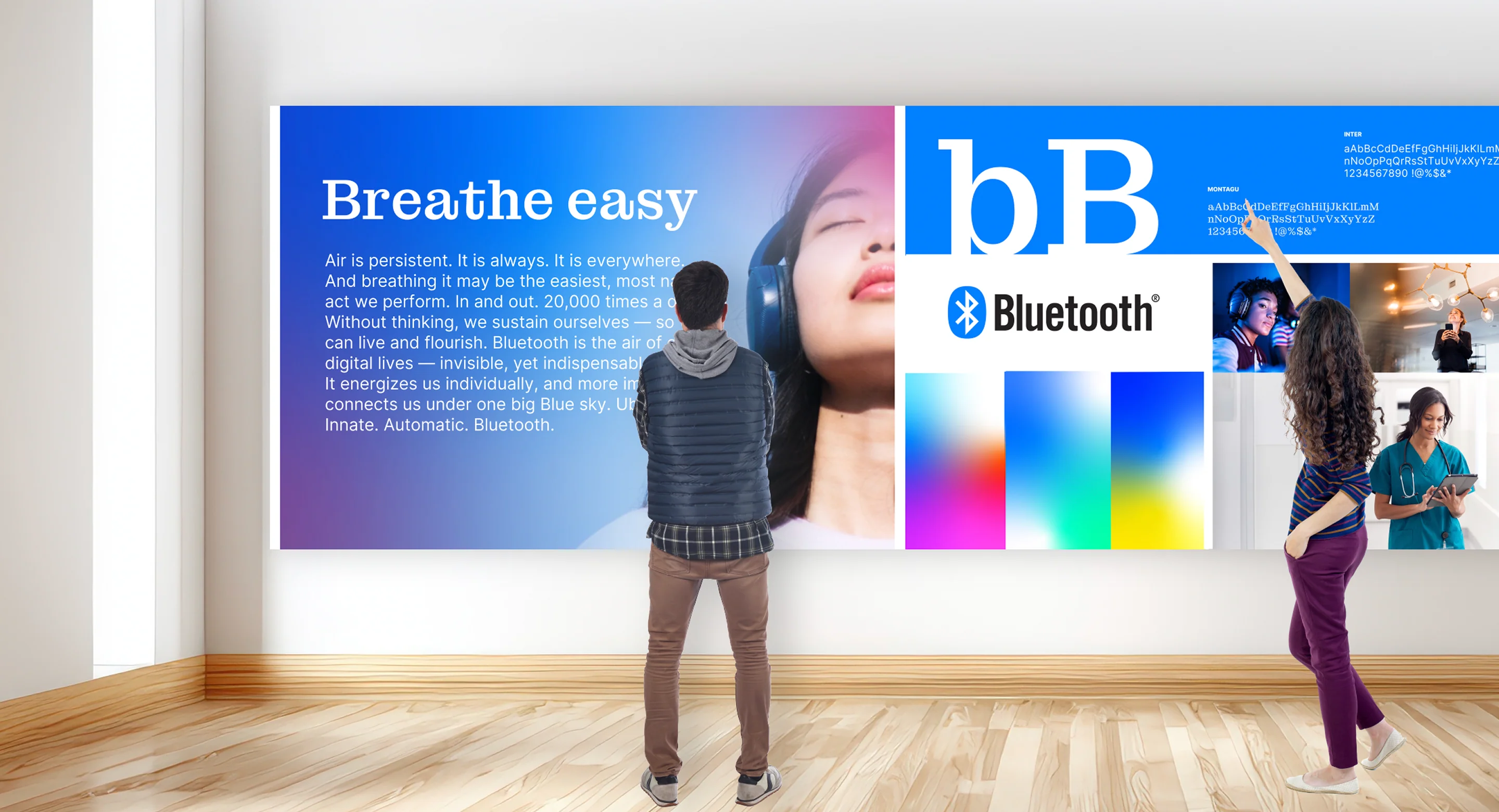 two people in front of a large wallboard that is highlighting Bluetooth's brand